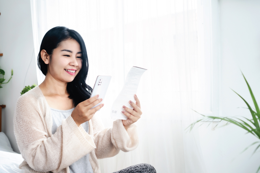 A woman taking a photo of a piece of paper