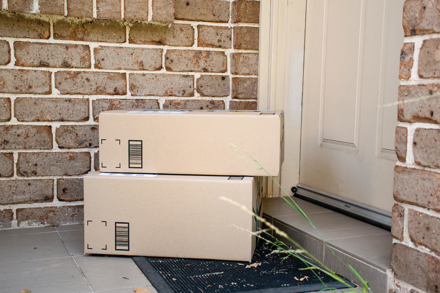 Two boxes sitting on a front porch