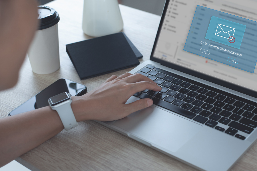 A hand resting on the keyboard of a laptop