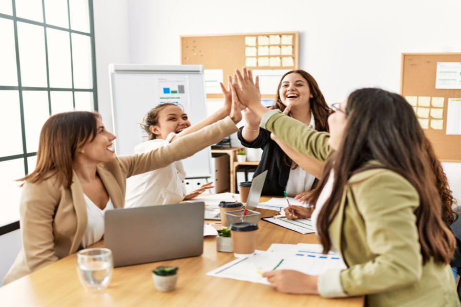 team of women high fiving