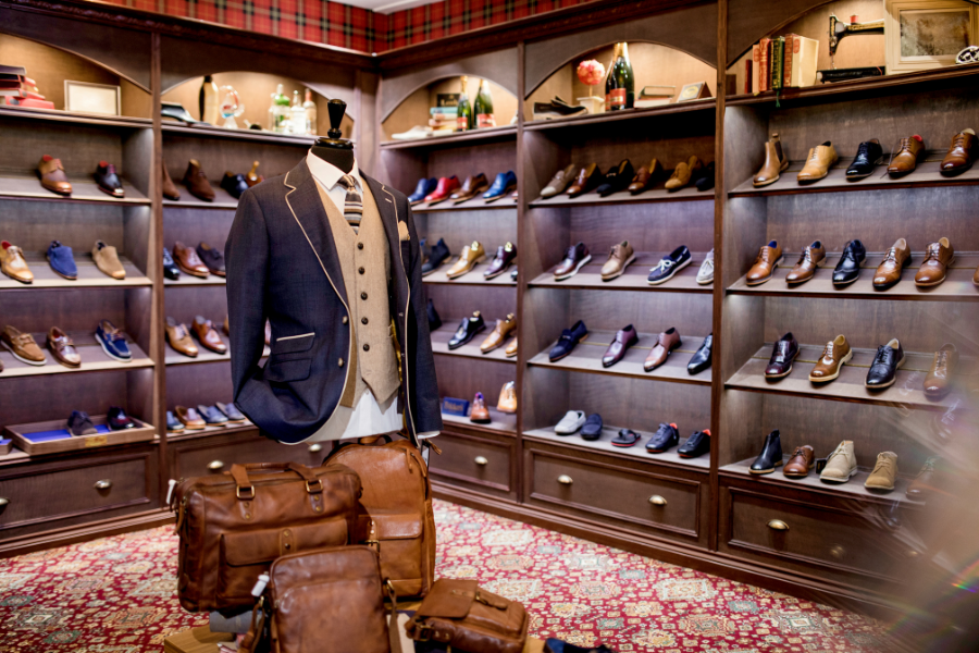 mens luxury store with high-end shoes, jackets, and briefcases on display