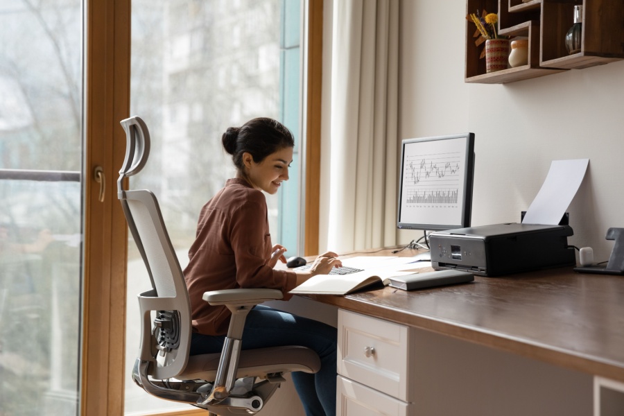 woman workingat her desk from her home office